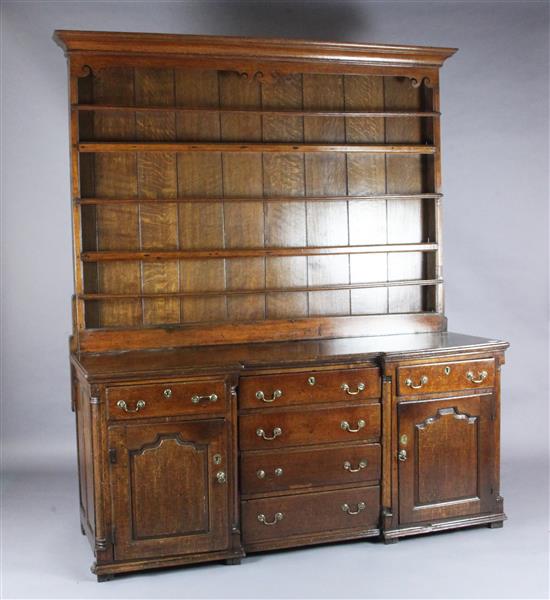 A mid 18th century oak inverse breakfront dresser, W.6ft 2in. D.1ft11in. H.7ft 2in.